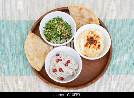 Assortment of dips: hummus, chickpea dip, tabbouleh salad, baba ganoush and flat bread, pita Stock Photo