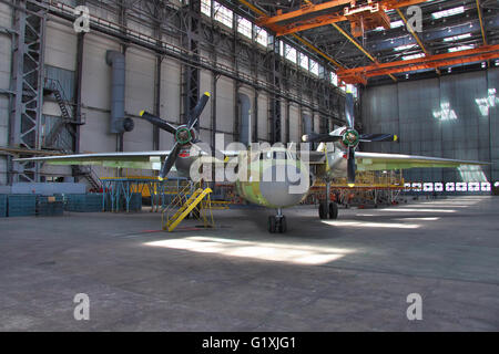 Kiev, Ukraine - August 3, 2011: Antonov An-32 cargo plane being final assembled at the aircraft manufacturing hangar Stock Photo