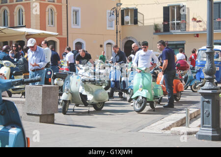 Arpino, Italy - May 30, 2010: unidentified people admiring 'Vespa' cycles, a typical oldstyle italian vehicle in Arpino's villag Stock Photo