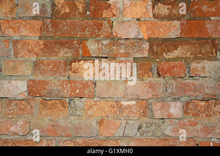 dilapidated wall of red brick Stock Photo
