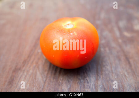 Fresh Red Tomato with blurry background on natural light. Stock Photo