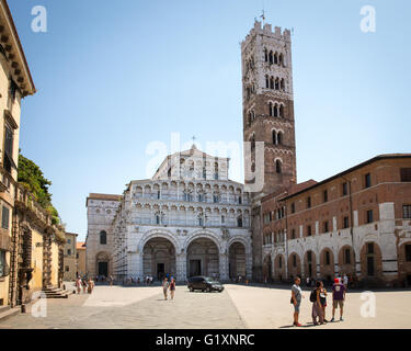 Lucca Cathedral, or Duomo di San Martino, and its bell tower in the Tuscan village of Lucca, Italy.  Tourists in the square. Stock Photo
