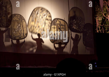 RATCHABURI THAILAND - APRIL 14, 2015: The Cowskin shows a man holding a stencil pattern. Moving Cowskin the light to shadow play Stock Photo