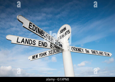 Iconic signpost against a blue sky at John O'Groats, Caithness in Scotland UK