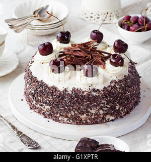 Black forest cake, Schwarzwald pie, dark chocolate and cherry dessert on a white wooden background. Stock Photo