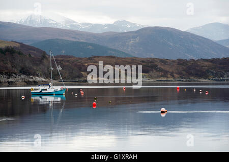 Mirror still reflection of boats in the Harbour at Ullapool, Wester Ross Scotland UK Stock Photo