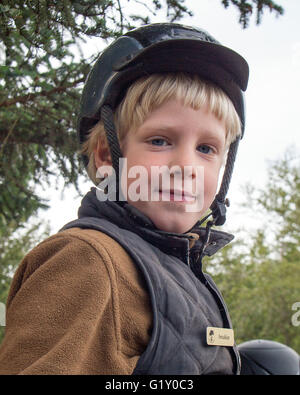 Selfoss, South Iceland, Iceland. 4th Aug, 2015. Portrait of a young boy at the Freidheimar family run farm in Selfoss, South Iceland. Besides horticulture, the family offers visitors a horse show featuring the Icelandic horse breed brought by the first settlers from Scandinavia around 900 AD. Tourism is a growing sector of the economy with Iceland becoming a favorite tourist destination. © Arnold Drapkin/ZUMA Wire/Alamy Live News Stock Photo