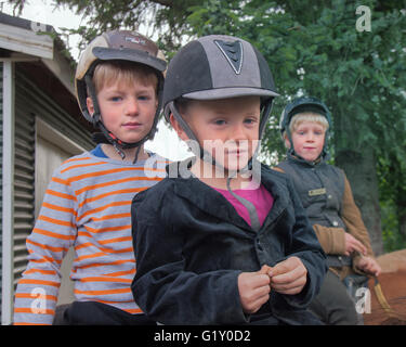 Selfoss, South Iceland, Iceland. 4th Aug, 2015. A trio of siblings atop their steeds at the Fridheimar family run farm in Selfoss, South Iceland. Besides horticulture, the family offers visitors a horse show introducing the Icelandic horse breed brought by the first settlers from Scandinavia around 900 AD. Tourism is a growing sector of the economy with Iceland becoming a favorite tourist destination © Arnold Drapkin/ZUMA Wire/Alamy Live News Stock Photo