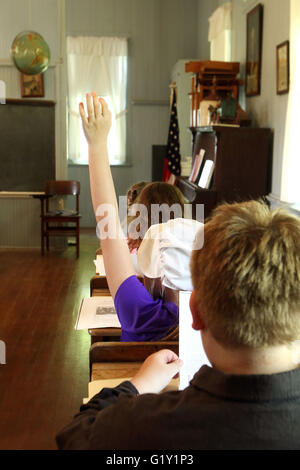 Miles, Iowa, USA. 19th May, 2016. Lexie Tebbe raises her hand and waits for teacher Heidi Lippens to call on her as her fourth-grade class spent the day at the old Teeds Grove No. 3 School at the Threshing Grounds in Miles, Iowa Thursday, May 19, 2016. Credit:  Quad-City Times/ZUMA Wire/Alamy Live News Stock Photo