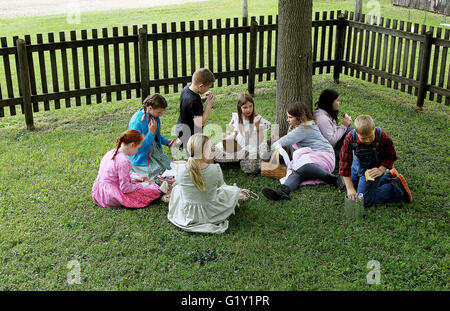 Miles, Iowa, USA. 19th May, 2016. Students take a lunch break outside the old Teeds Grove No. 3 School at the Threshing Grounds in Miles, Iowa Thursday, May 19, 2016. Credit:  Kevin E. Schmidt/Quad-City Times/ZUMA Wire/Alamy Live News Stock Photo