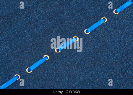 Fashionable background, blue satin ribbon inserted in denim, with space for your creativity Stock Photo