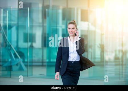 Businessman talking on mobile phone in financial district Stock Photo