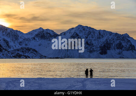 Stroller on snowy Haukland beach, Vestvågøy, Lofoten, Nordland, Norway Stock Photo