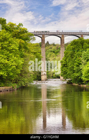 Pontcysyllte Aqueduct, built by Thomas Telford, and a World Heritage Site, reflecting in the River Dee, with a narrowboat and... Stock Photo
