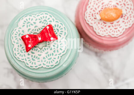Colorful Ceramic Round Jars With Lace Patterns Stock Photo