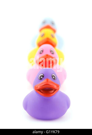 Line of colorful rubber ducklings, on white Stock Photo