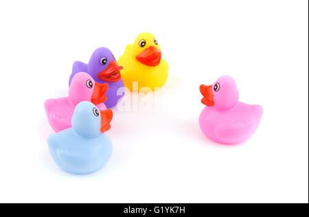 One rubber duckling speaking in front of a group of ducklings - concept of conversation or teaching