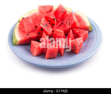 Watermelon slices and pieces on a blue plate, on white Stock Photo