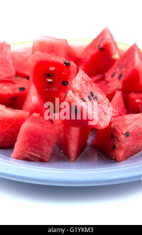 Vertical closeup of watermelon chunks on a blue plate Stock Photo