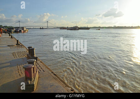 River jetty with Second Hooghly bridge at a distance, Kolkata, West Bengal, India Stock Photo