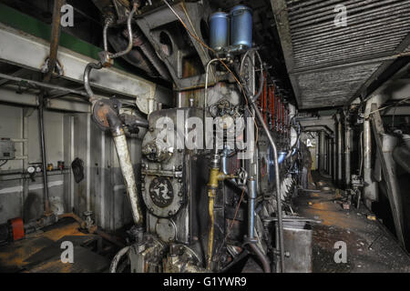 The ship's hold with diesel engine mounted on ship. Engine room on a old cargo boat ship. Focus, on, the, center, of, frame Stock Photo