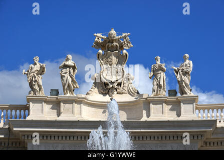 Detail from baroque Saint Peter's colonnade with beautiful statues of saints and Pope Alexander VII coat of arms Stock Photo