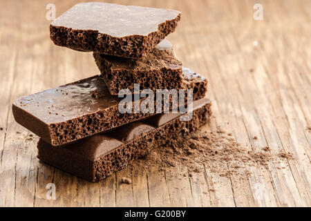 part porous chocolate close-up on a wooden background Stock Photo