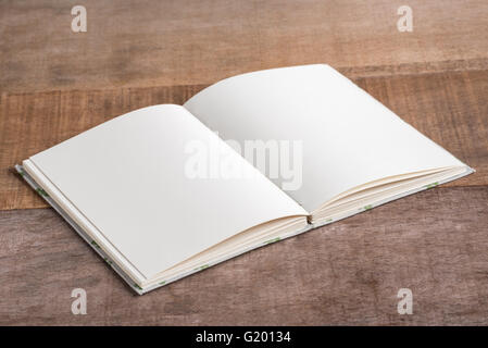 Closeup of opened handmade book on wooden background Stock Photo