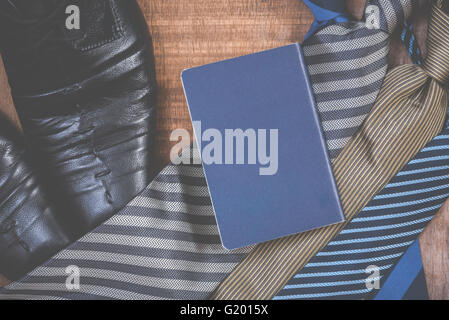 Necktie and shoes,passport on grunge wood background Stock Photo