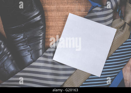 Necktie and shoes on grunge wood background Stock Photo