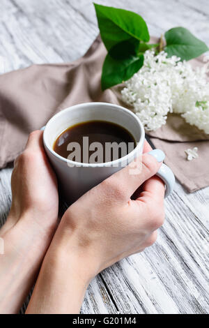 Cup of coffee in hands Stock Photo