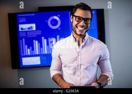 Handsome businessman standing and smiling Stock Photo
