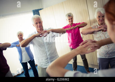 Group of seniors doing exercises with nurse Stock Photo