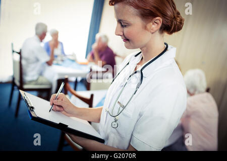 Portrait of a nurse with clipboard Stock Photo