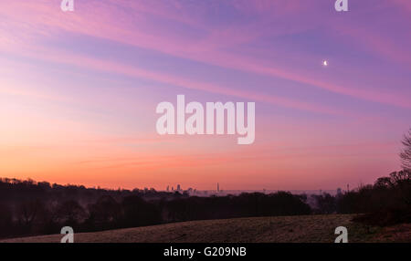 Stunning colours of the sunrise over the London skyline from Hampstead Heath, UK. Stock Photo