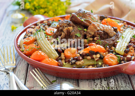 Beans with vegetables and meat on a plate Stock Photo