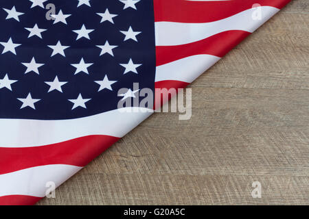 fragment of USA flag folded on wooden walnut table with copy space Stock Photo