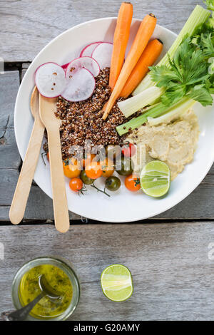 Quinoa with fresh celery,carrot and hummus salad Stock Photo