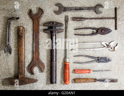 Old rusty tools arranged on the floor Stock Photo