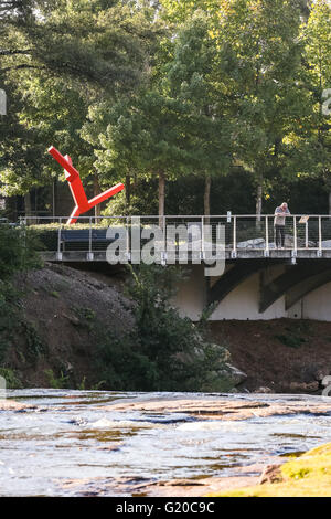 Tourists view the Reedy River falls from the Liberty Bridge in downtown Greenville, South Carolina. Stock Photo