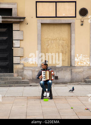 Girl street busker in Warsaw Poland playing a piano accordion Stock Photo