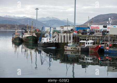 Mirror still reflection of boats in the Harbour at Ullapool, Wester Ross Scotland UK Stock Photo