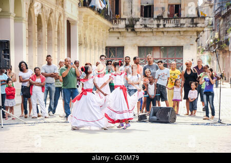 HAVANA, CUBA - JANUARY 1, 2013 Local kids in traditional outfits perform dancing and singing on street in Old Havana, Cuba. Stock Photo