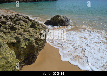 Sea foam meets Sand in Albandeira beach. Algarve, Portugal Stock Photo