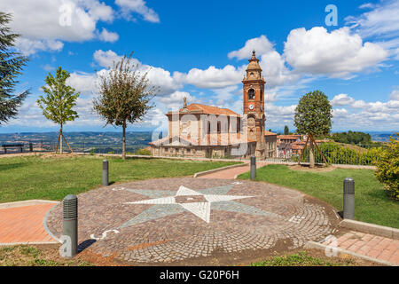 Viewpoint and old parish church under beautiful sky on background in small italian town in Piedmont, Northern Italy. Stock Photo