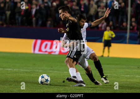 Paulo Dybala of Juventus (L ) and Coke of Sevilla (R ) fight for the ball during the UEFA Champions League Group D soccer match between Sevilla FC and Juventus at Estadio Ramon Sanchez Pizjuan in Sevilla, Spain, 8 December, 2015 Stock Photo