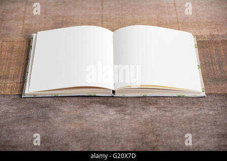 Closeup of opened handmade book on wooden background Stock Photo