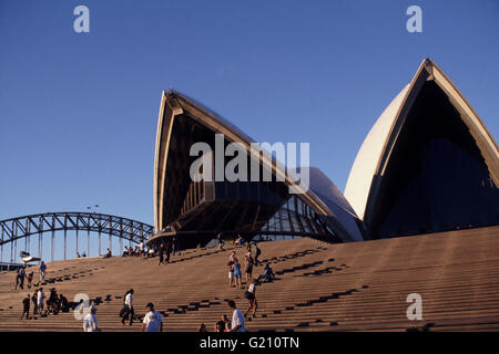 Visitors adorn the steps of the Sydney Opera House designed by Architect Jorn Utzon, in Sydney, New South Wales, Australia. Stock Photo