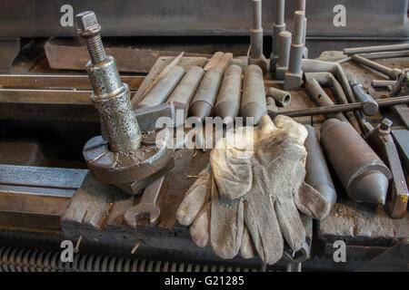 Work gloves and old tools on workbench. Stock Photo
