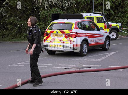 Worcester Park, Surrey, UK. 21st May 2016. Clouds of black, billowing smoke rise from a fire on B284 Old Malden Lane in Worcester Park, Surrey. At around 7.30pm multiple fire crews, police and ambulances attended the fire beside the Hogsmill Toby Carvery Pub. Police have confirmed that burning tyres at an industrial yard caused the excessive amounts of black smoke. By around 8.00pm the fire was under control. Credit:  Julia Gavin UK/Alamy Live News Stock Photo